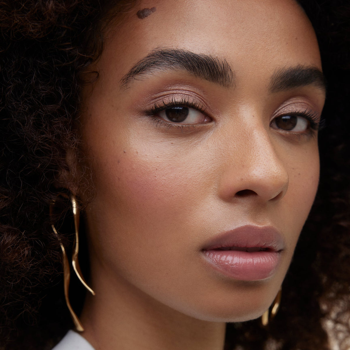 Closeup of woman's face wearing Wonderblush makeup.