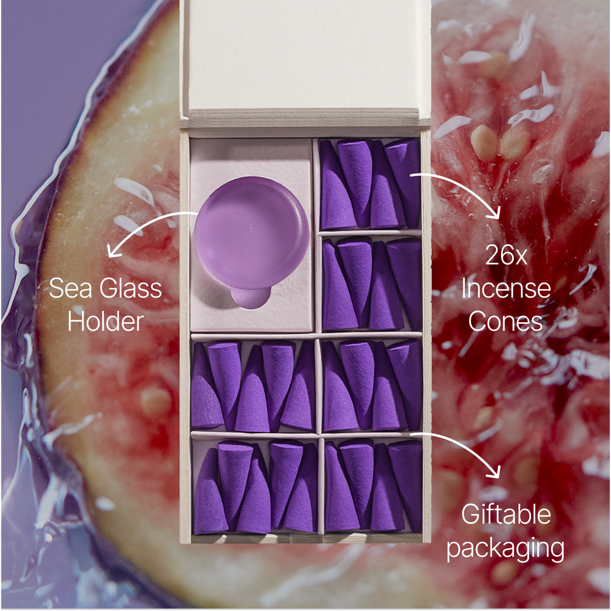 An open gift box containing a lavender-colored sea glass holder and 26 purple incense cones, set against a background of sliced figs with text overlays highlighting the product components.