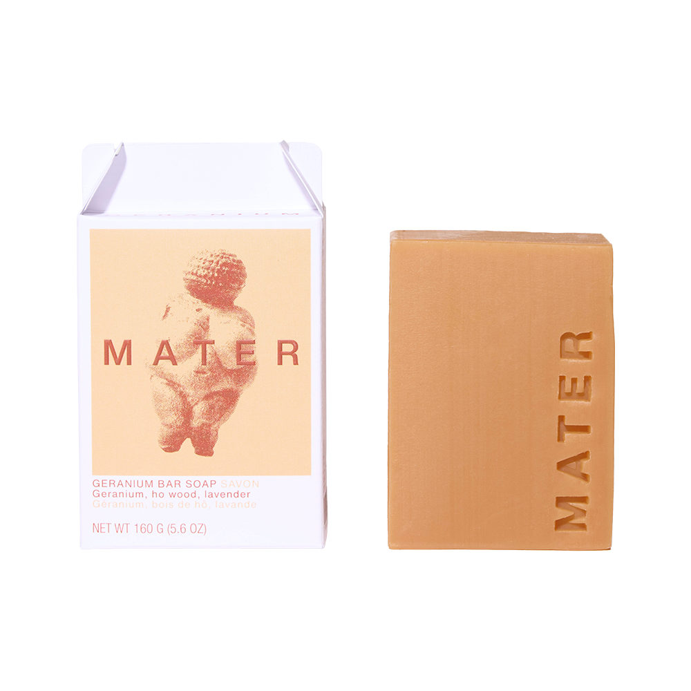 MATER Geranium Bar Soap shown next to its white and peach-colored cardboard packaging box on a clean white background.
