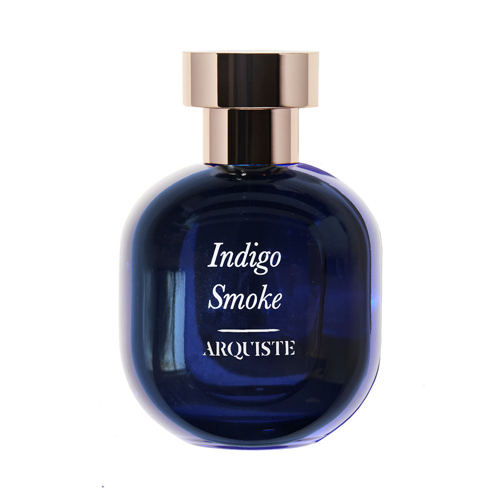 A blue bottle of 'Indigo Smoke' eau de parfum with a metallic cap, labelled in a clear and elegant font.