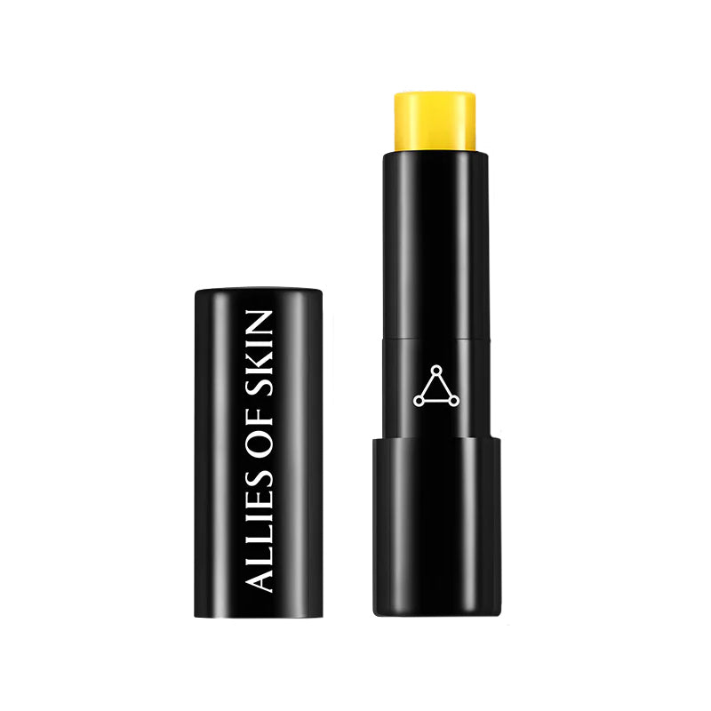 Black makeup stick with yellow cap and 'Allies of Skin' branding on a white background