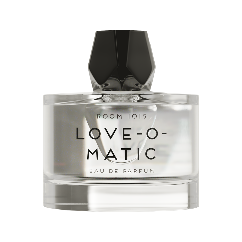 A clear glass bottle of Room 1015 Love-O-Matic Eau de Parfum with a faceted black cap, shown against a plain white background.