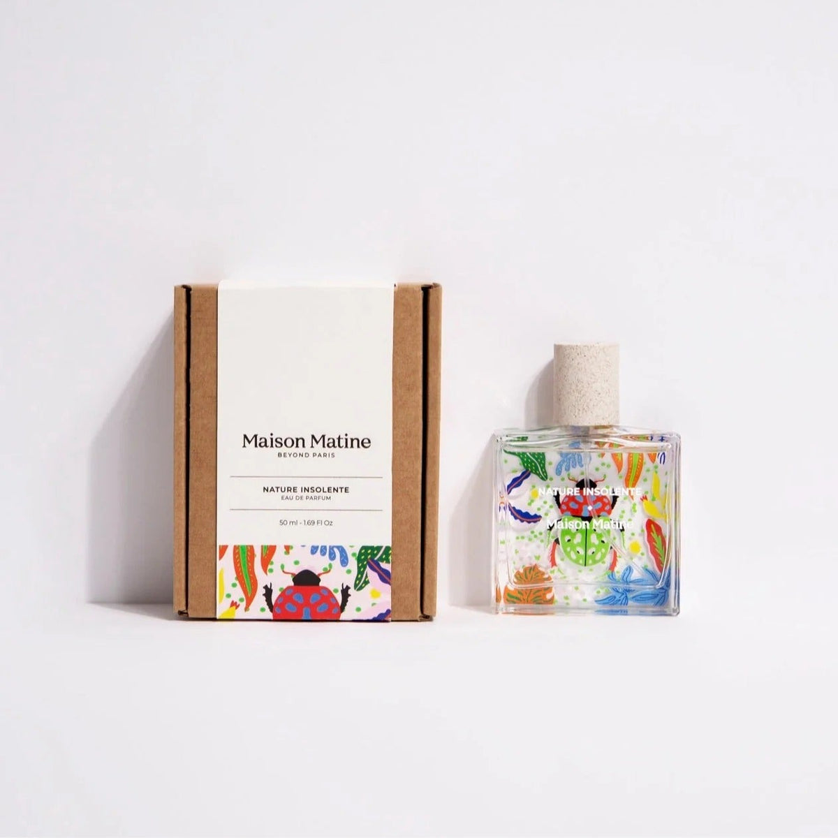 Maison Matine perfume bottle with colorful design and packaging on a white background