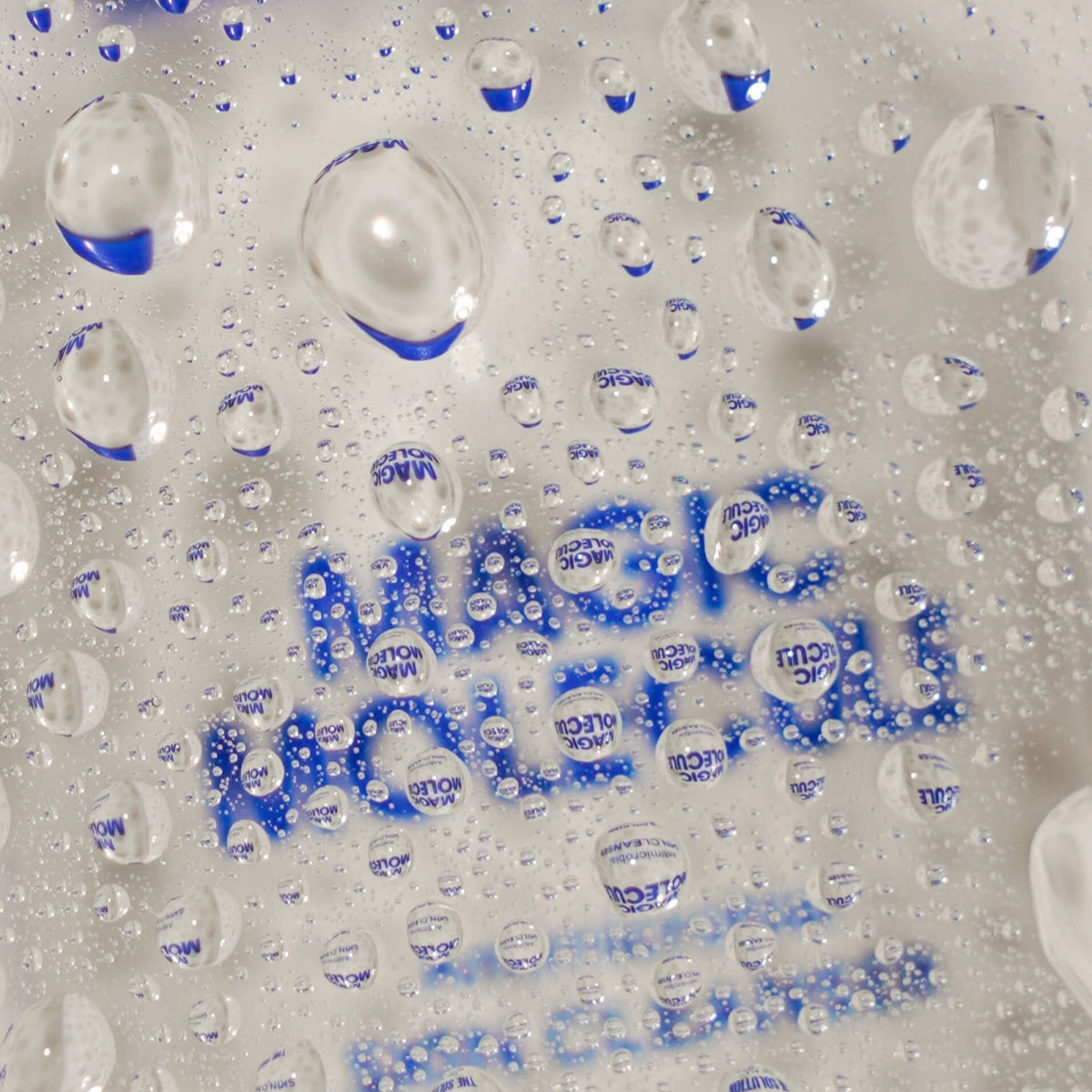 Magic Molecule logo behind misty water droplets.