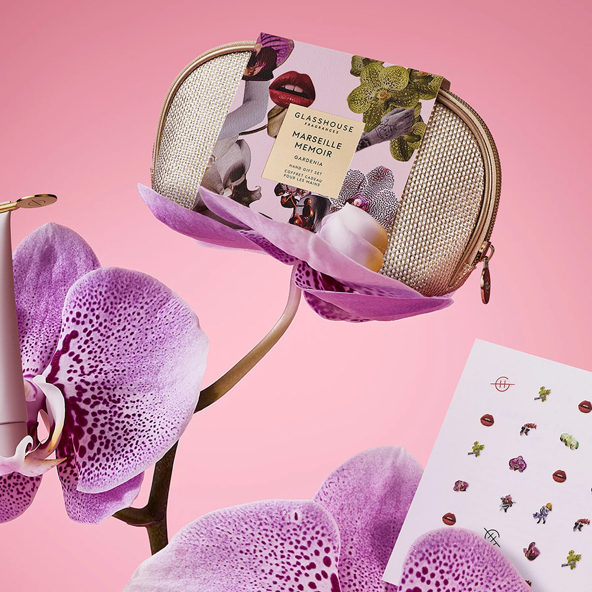 Glasshouse Marseille Noir soap in a decorative pouch with pink orchids on a pink background