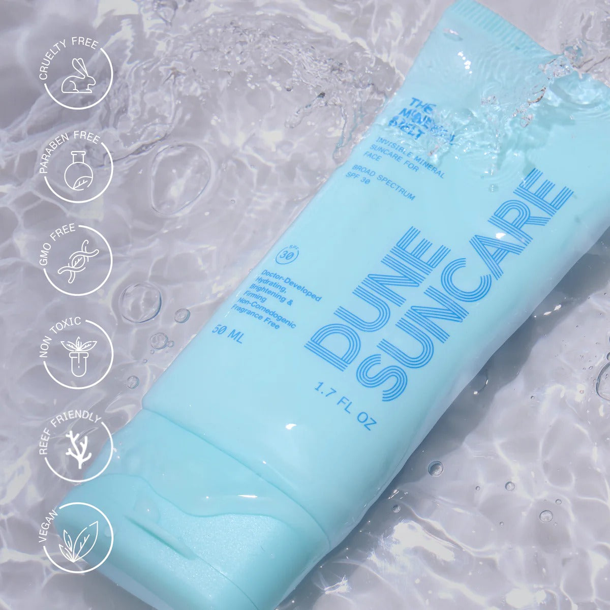 Dune Mineral Melt sunscreen bottle on a water droplet background