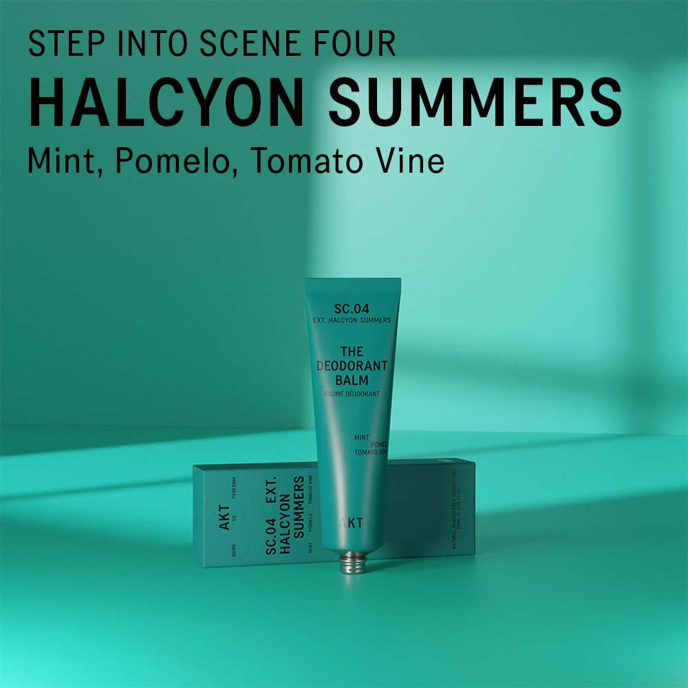 AKT Halcyon Summers scented deodorant balm standing on and in front of a teal surface. Text overlaid on the image above the product reads "Step into scene four. Halcyon Summers. Mint, Pomelo, Tomato Vine."