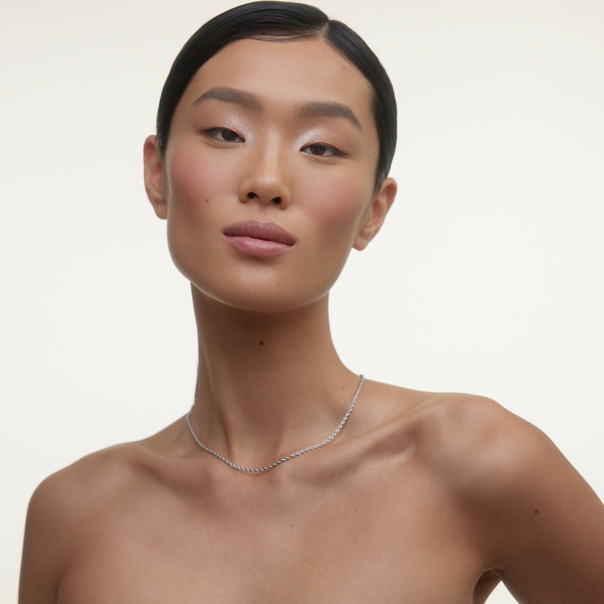 Woman wearing Wonderblush makeup products. 