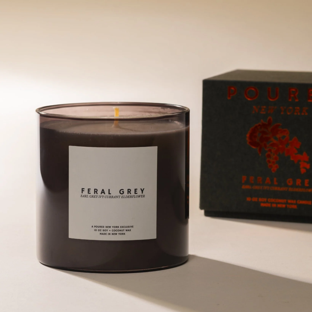 Feral Grey candle with a matching box on a light background