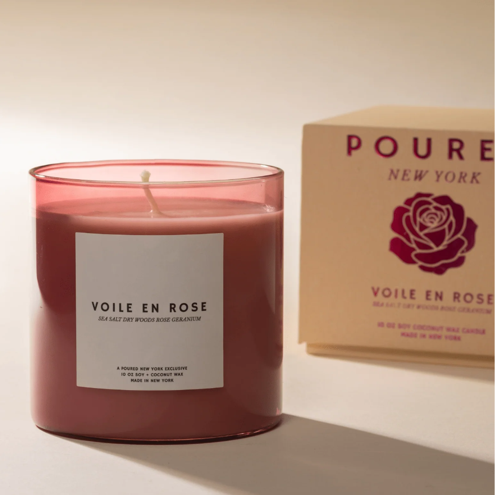 Pink candle labeled 'Voile En Rose' with a matching box on a light background