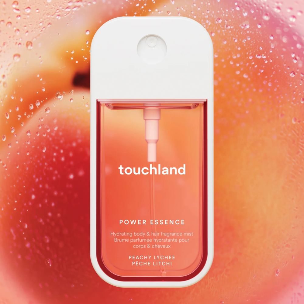 Touchland Power Essence bottle on a peach background
