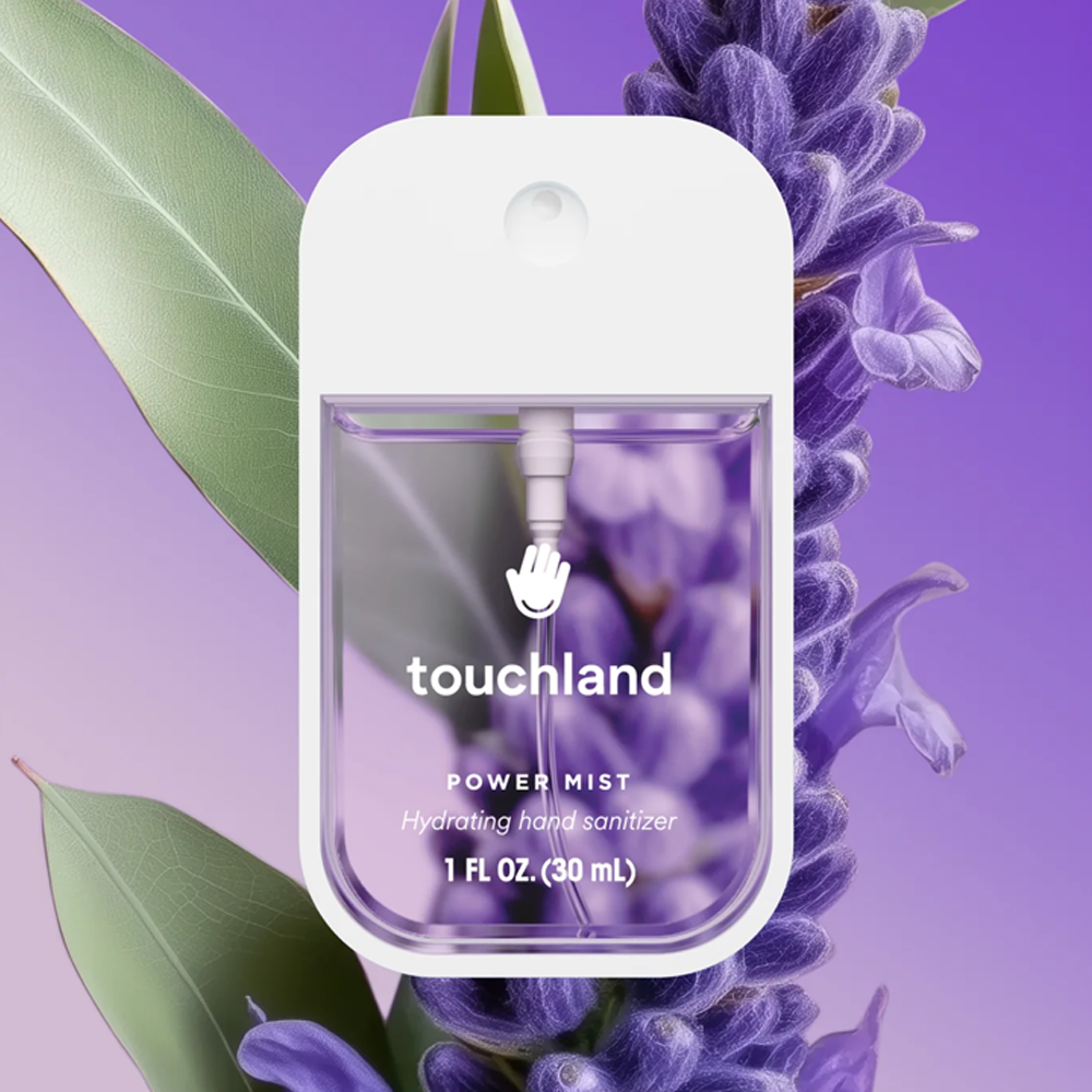 Touchland power mist hand sanitizer bottle with lavender flowers and leaves on a purple background