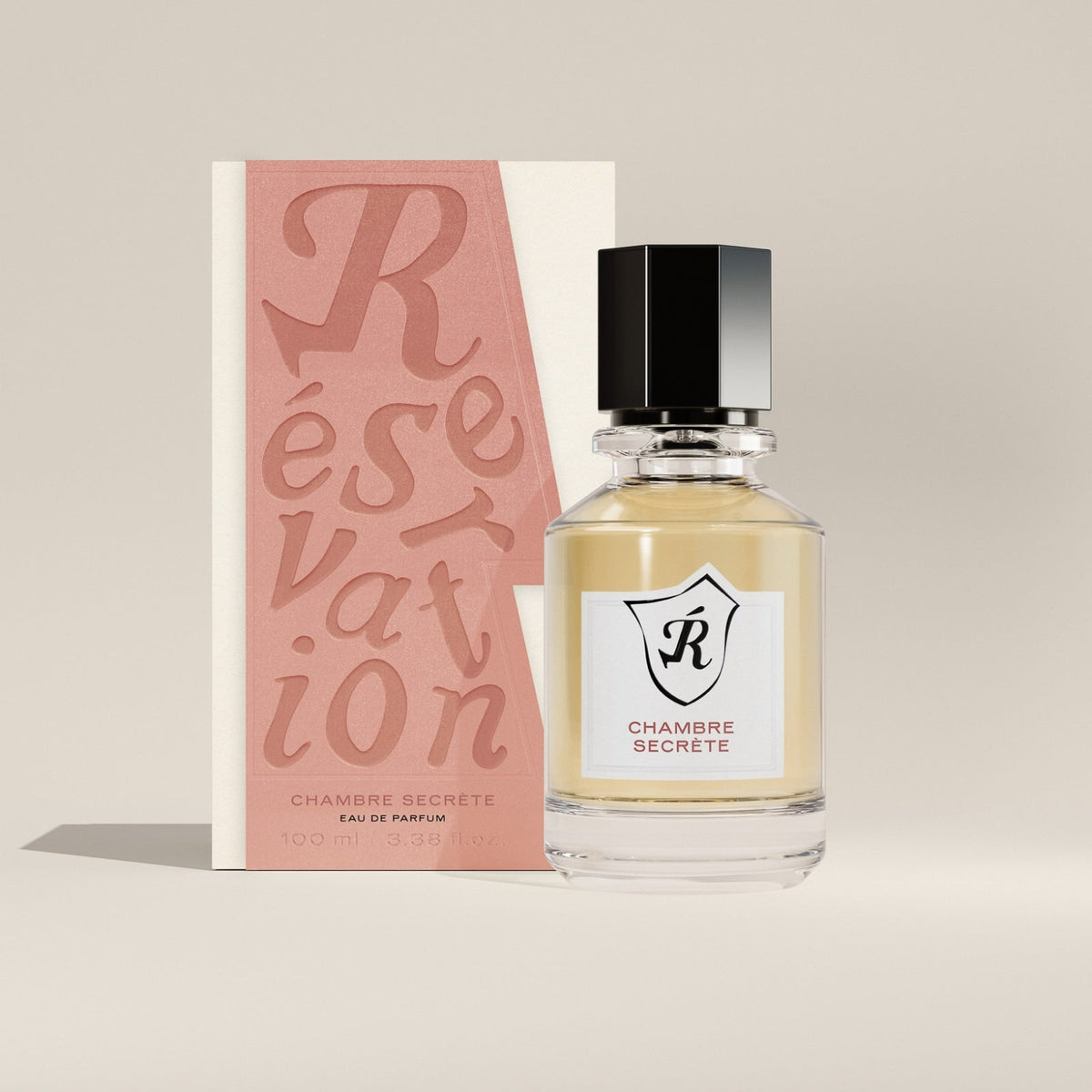 Perfume bottle with packaging labeled 'Réservation' on a beige background