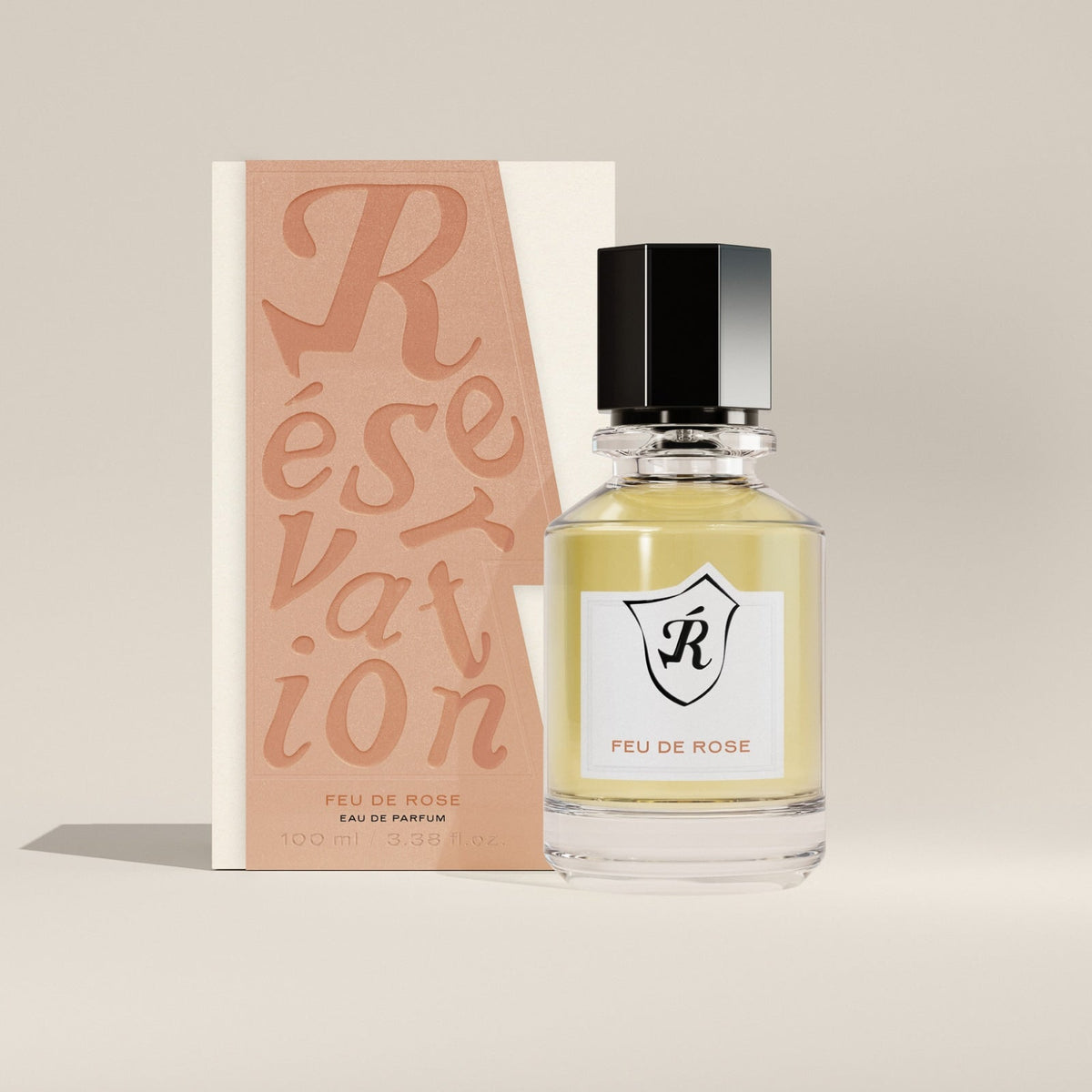 Perfume bottle and packaging with 'Réservation' branding on a neutral background