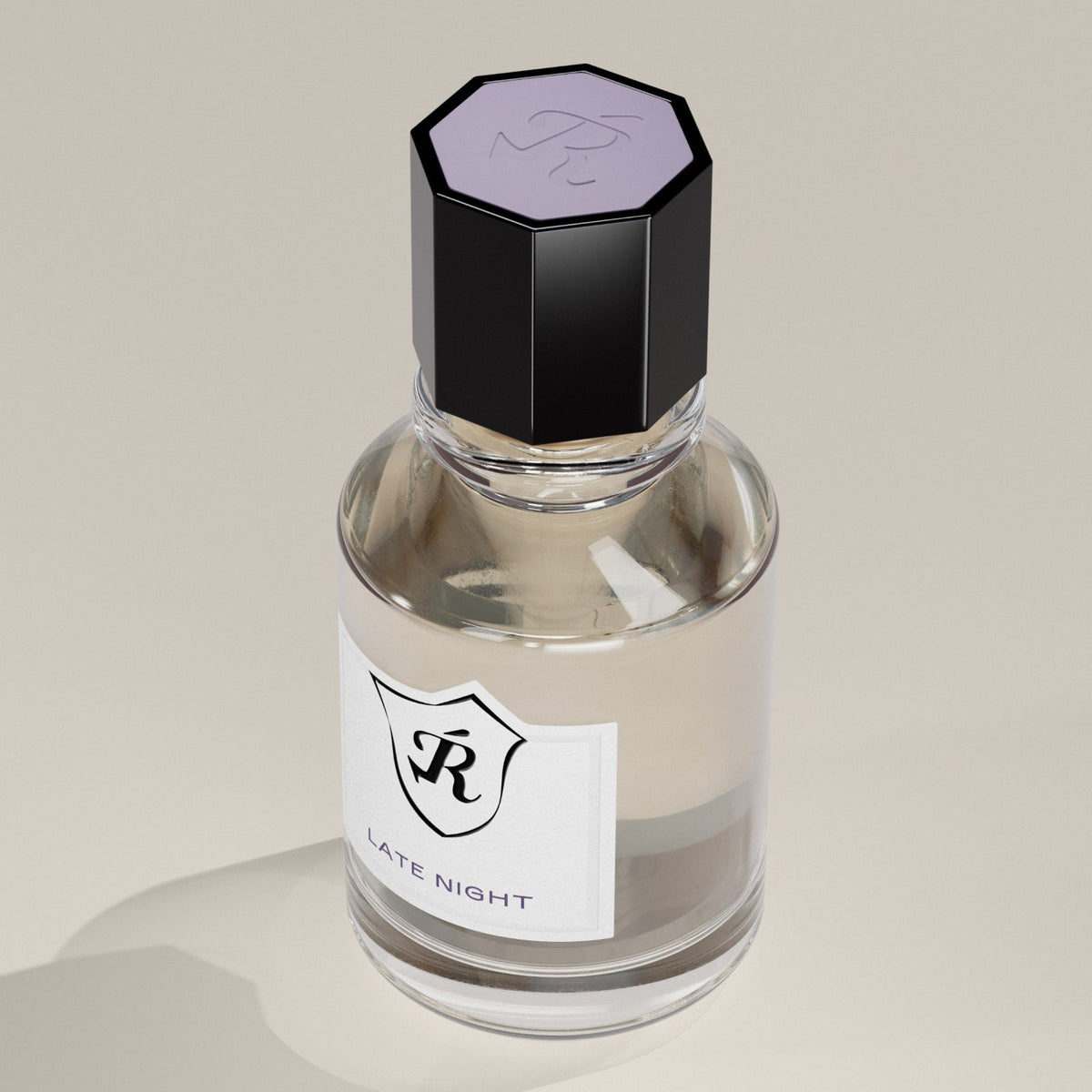 Perfume bottle with a black cap and white label on a beige background