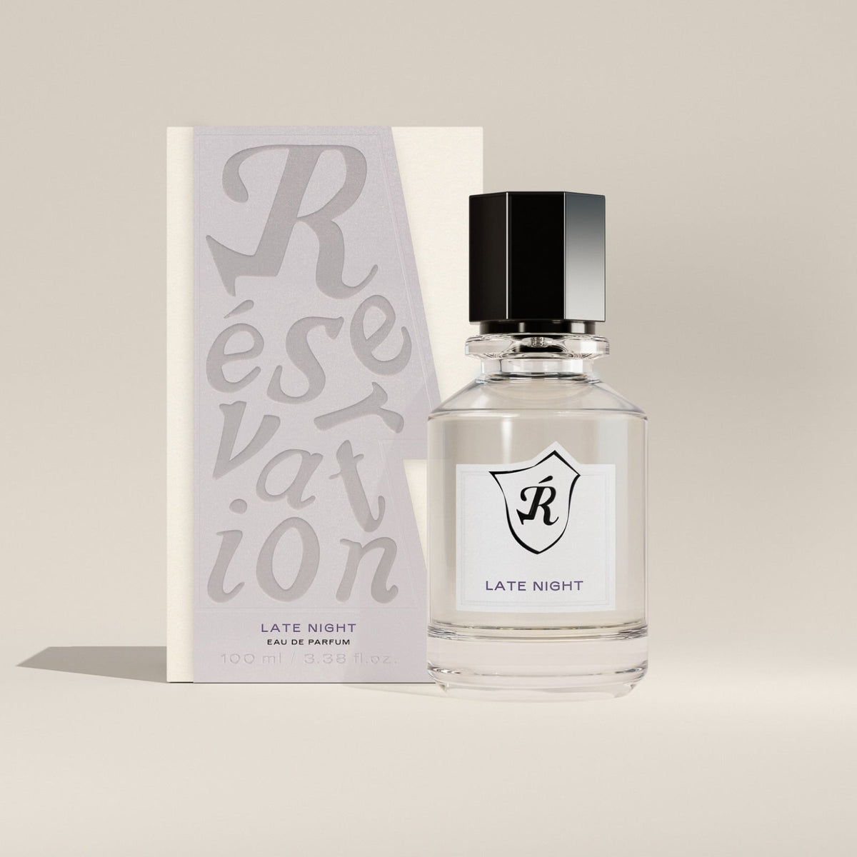 Perfume bottle labeled 'Late Night' by 'Reservation' with packaging on a beige background