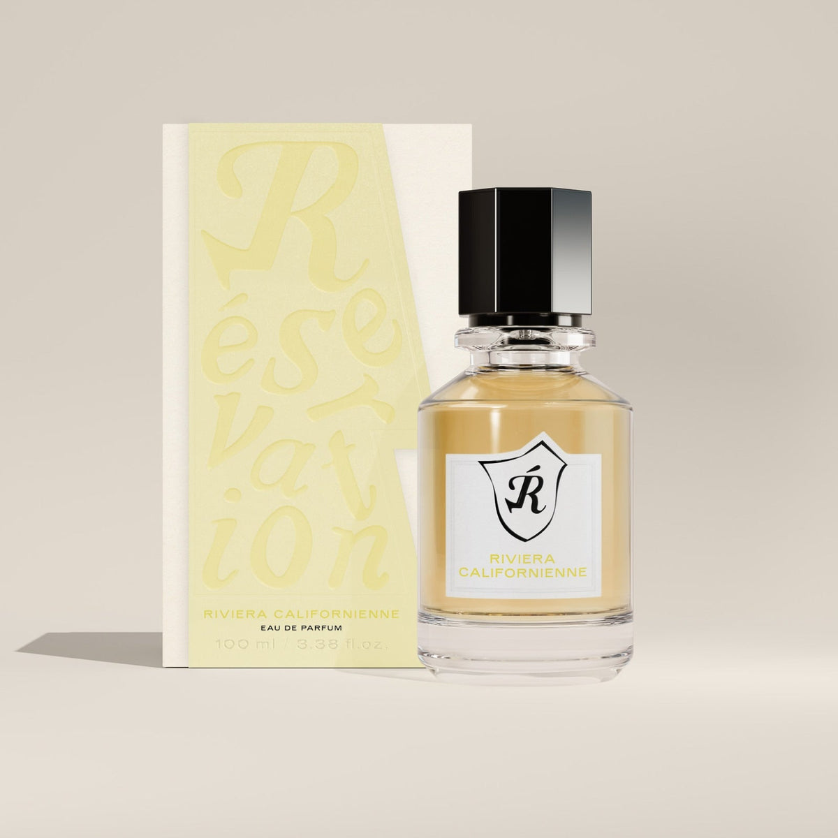 Reservation Perfume bottle with packaging on a beige background.