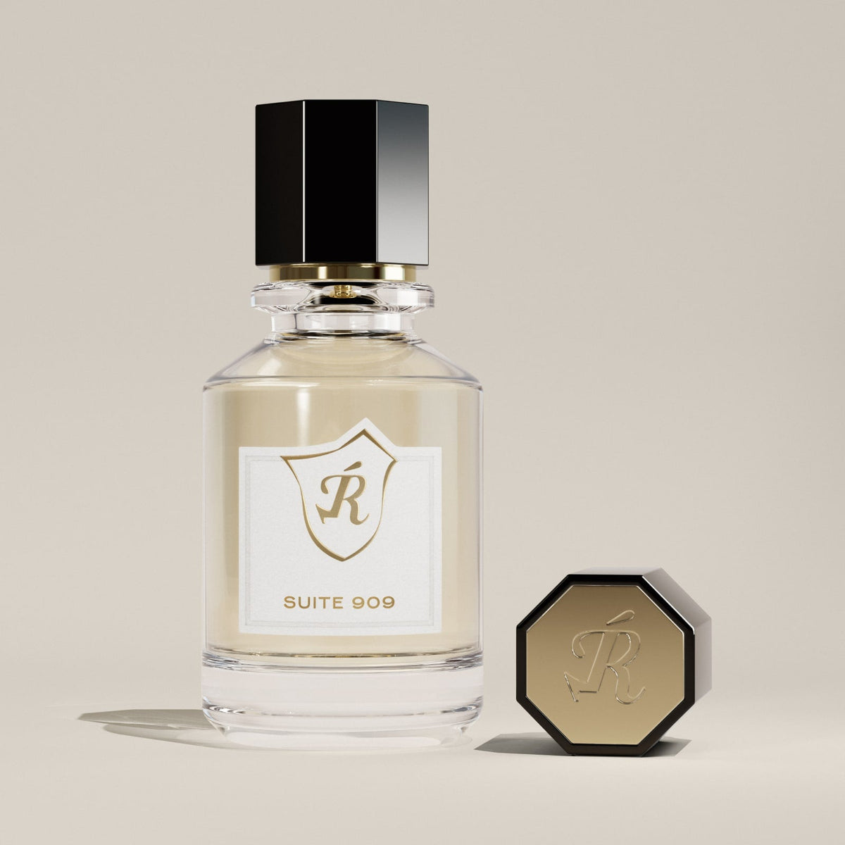 Perfume bottle with hexagonal cap and gold accents on a beige background