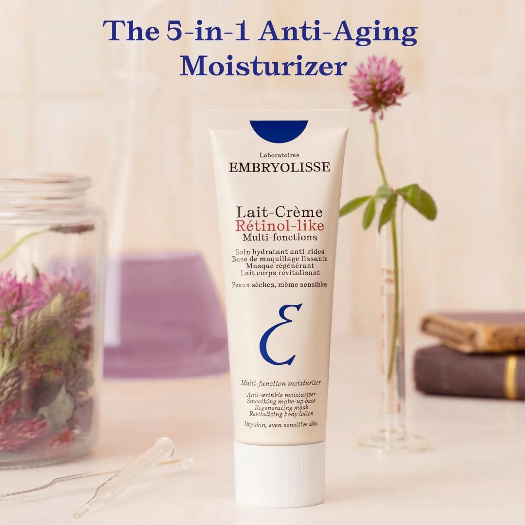 Embryolisse Lait-Creme Retinol-Like next to flowers and books underneath text that reads "The 5-in-1 Anti-Aging Moisturizer."