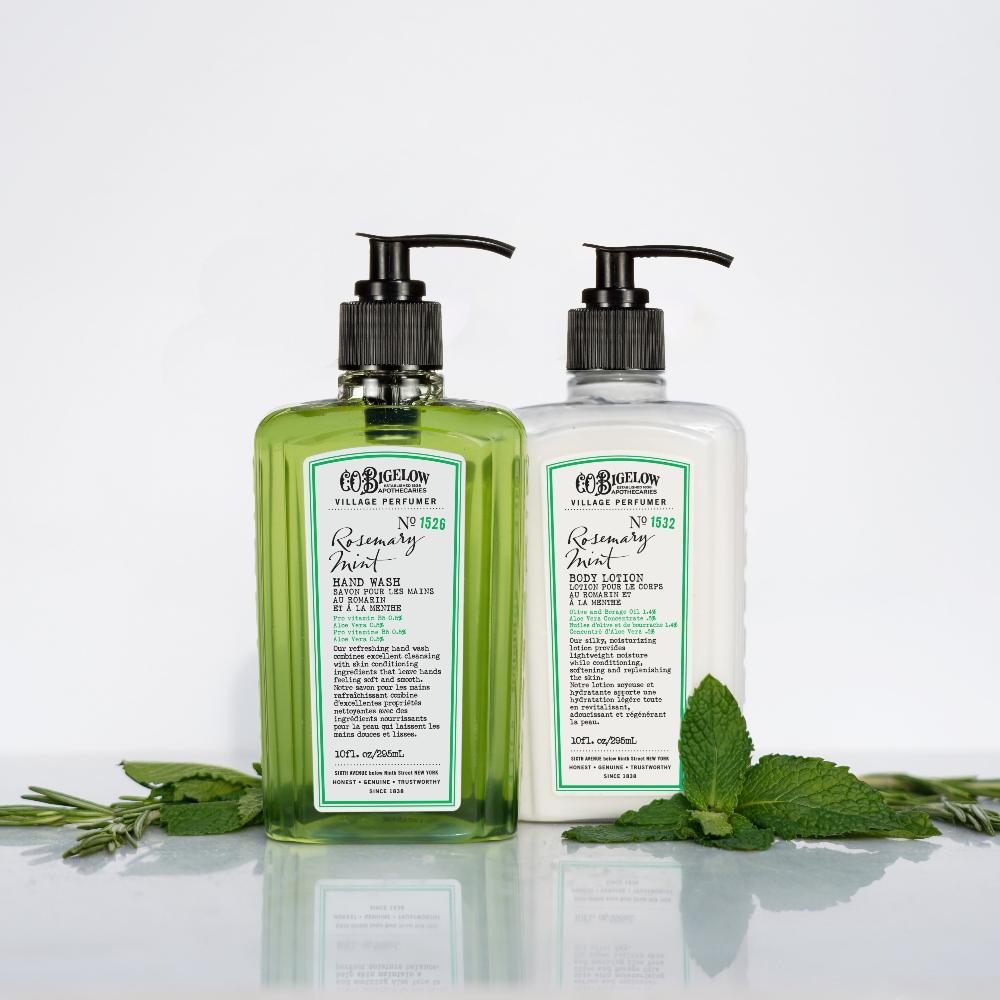 CO Bigelow Rosemary Mint Hand Wash and Body Lotion along mint and rosemary leaves on white background 