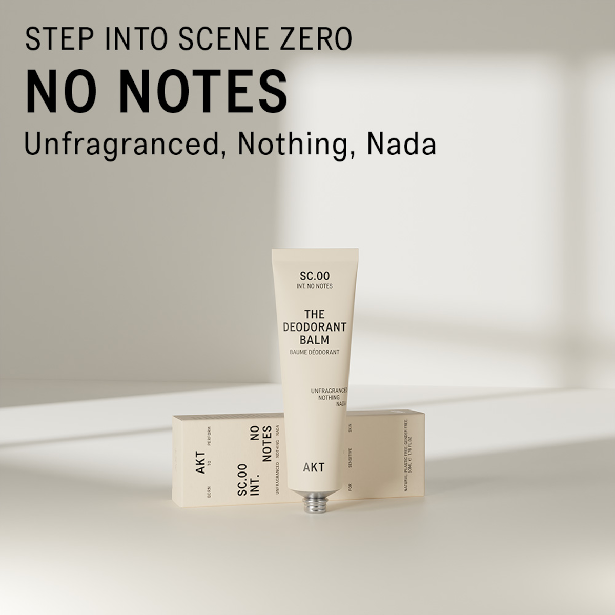 AKT unscented deodorant balm standing on and in front of a white surface. Text overlaid on the image above the product reads "Step into scene zero. No Notes. Unfragranced, Nothing, Nada."