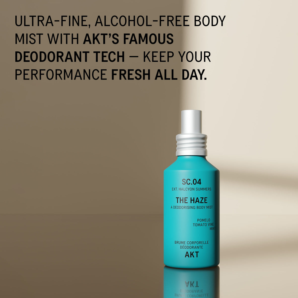 Bottle of AKT The Haze SC. 04 Halcyon Summers stands on a reflective surface against a warm beige background, with large promotional text at the top describing an alcohol-free body mist and deodorant tech.