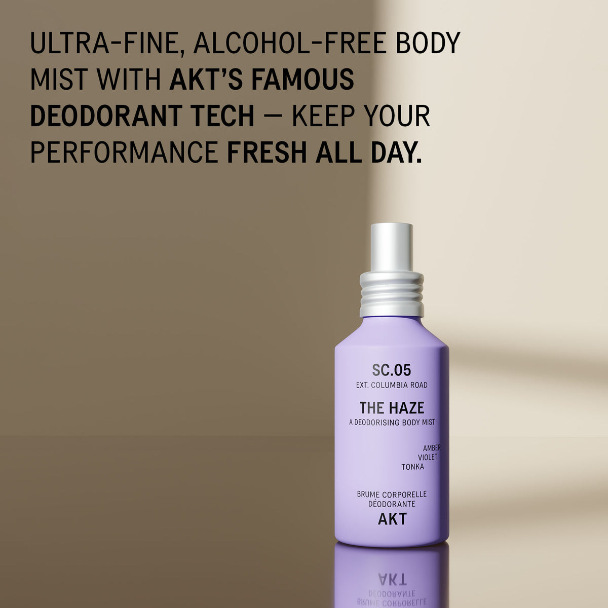 Bottle of AKT The Haze SC. 05 Columbia Road with a white spray cap, displayed on a reflective surface against a beige background with promotional text at the top.
