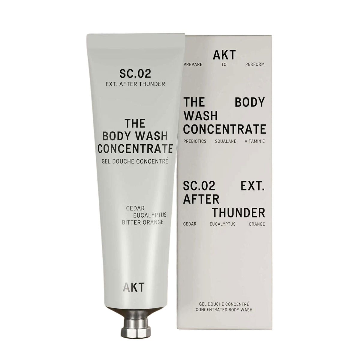 Gray Tube of AKT's Body Wash Concentrate in scent "After Thunder" next to gray packaging box. 