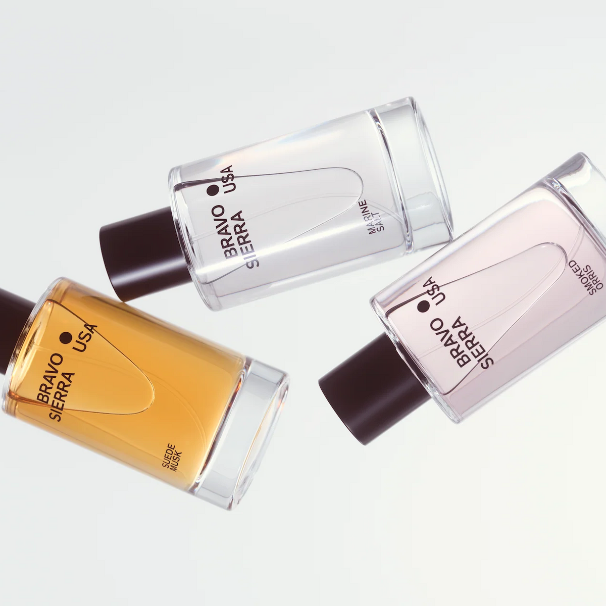 Three perfume bottles from Bravo Serra on a light gray background