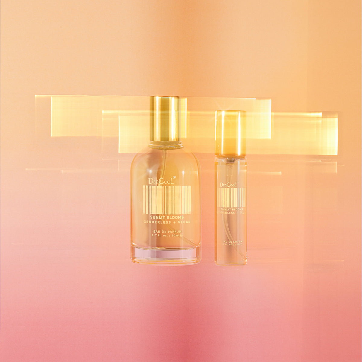 Sunlit Blooms EDP Travel and full size on an orange and pink ombre background.