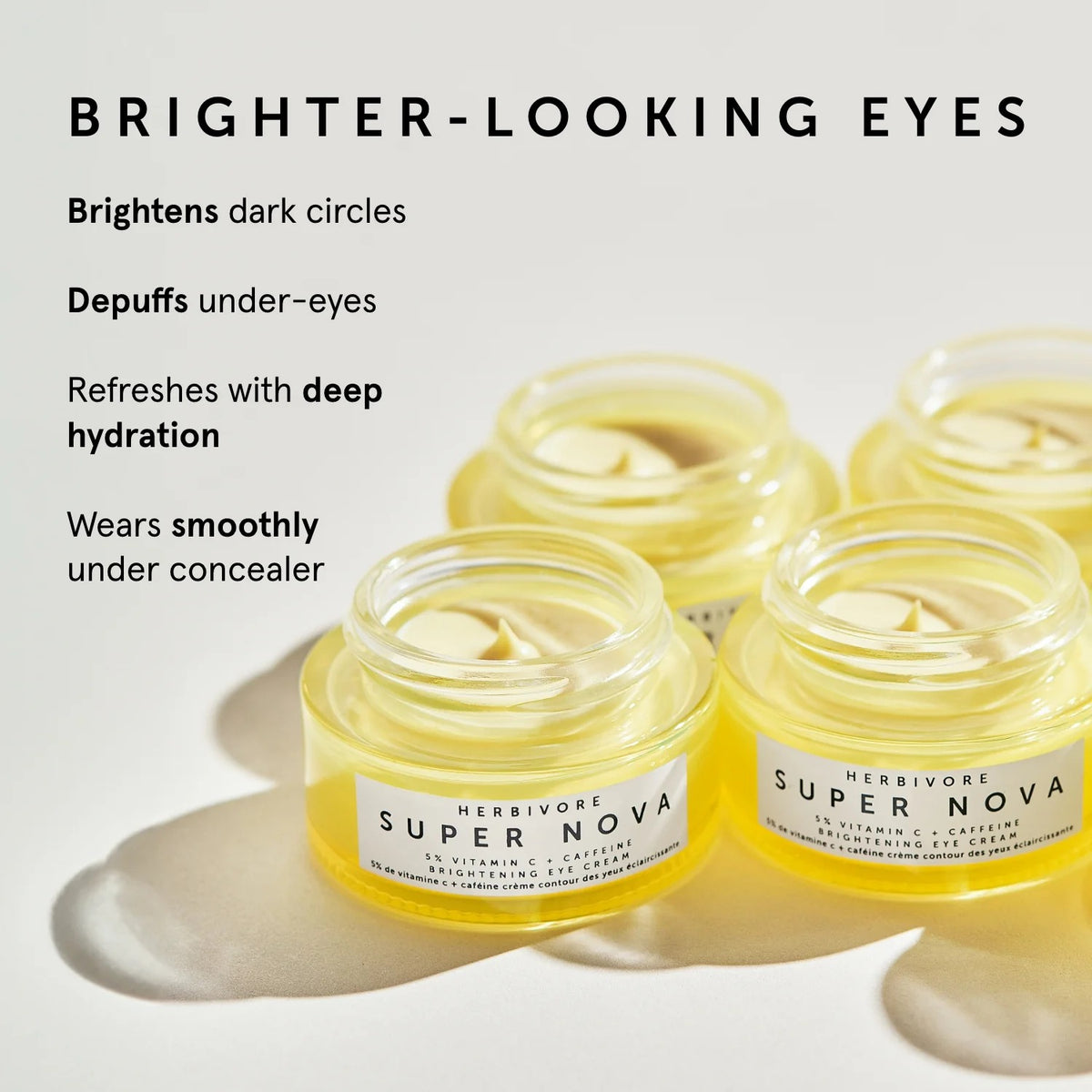 Herbivore Super Nova eye cream jars with text highlighting benefits on a light background