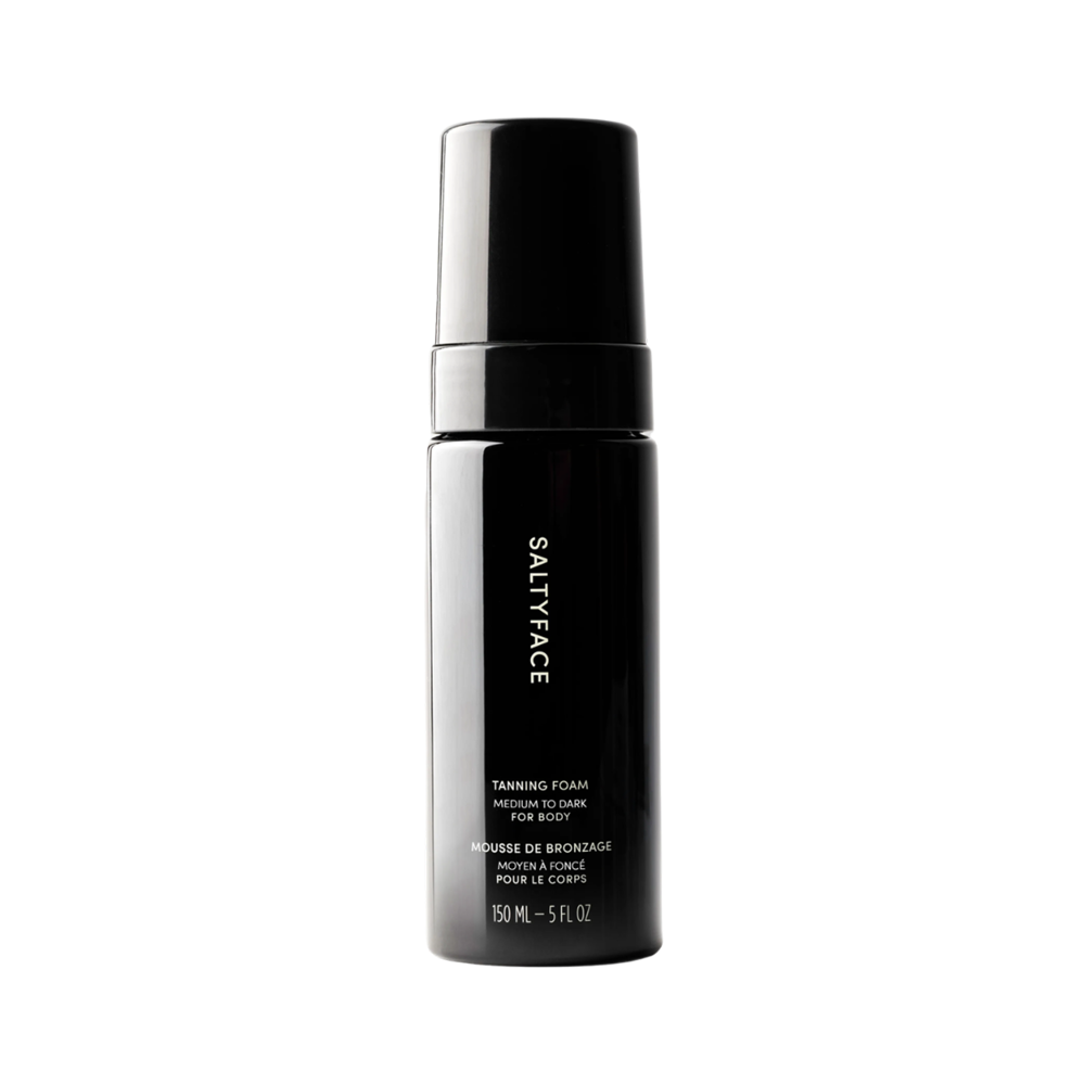 Black bottle of Saltyface tanning foam on a white background