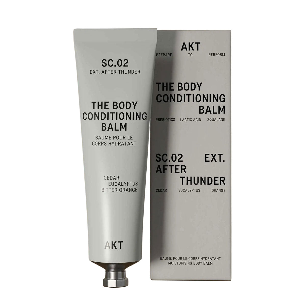 AKT's After Thunder Body Conditioning Balm tube to the left of it's gray packaging box in front of a white background.