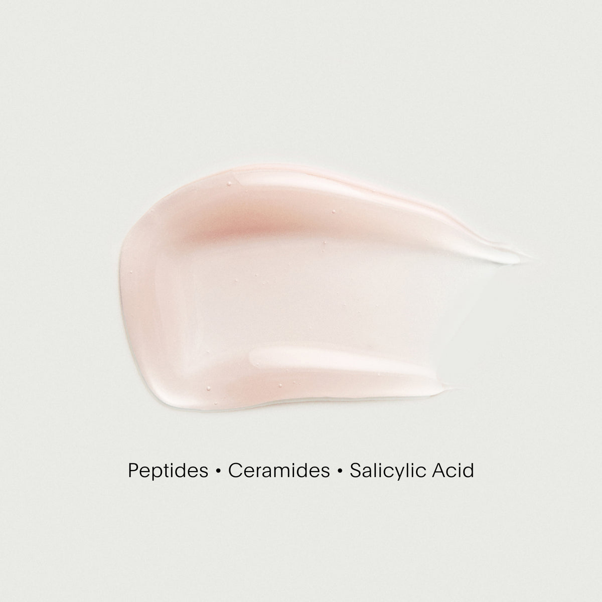 Pink cream swatch with text 'Peptides • Ceramides • Salicylic Acid' on a white background