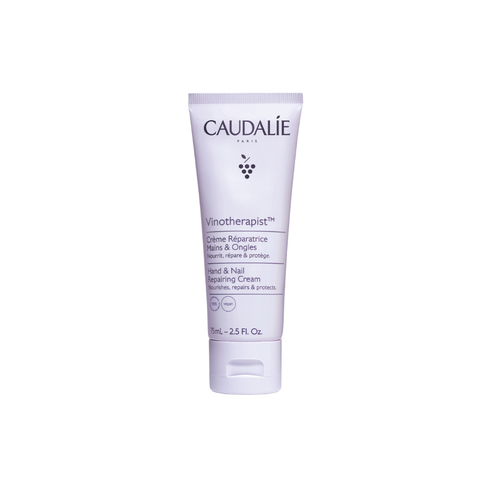 Caudalie hand and nail repairing cream tube on a white background