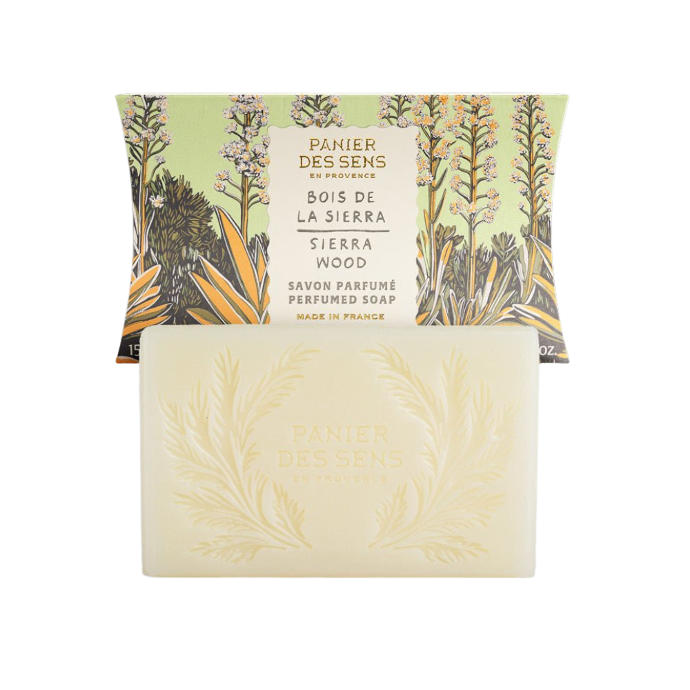 Sierra Wood Bar of soap with packaging featuring botanical design and branding on a white background