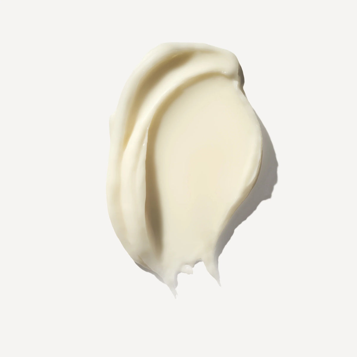 Swirl of light beige cream on a white background