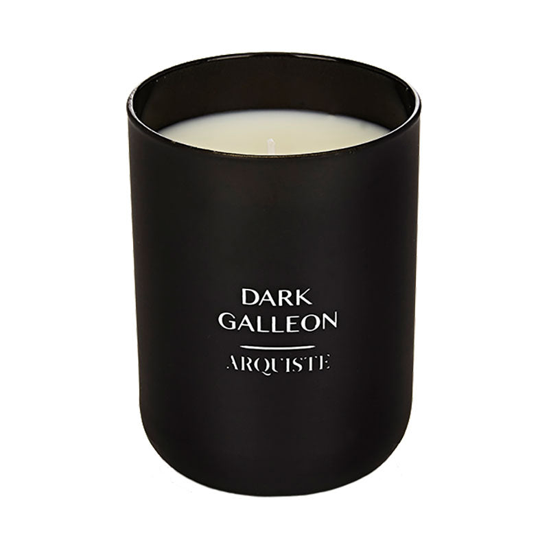A black candle jar with a white candle inside, labeled 'DARK GALLEON' by ARQUISTE.