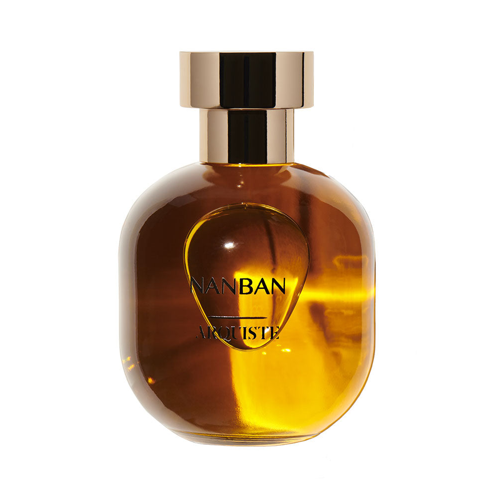 A bottle of NANBAN Eau de Parfum with a clear, amber-colored liquid visible.