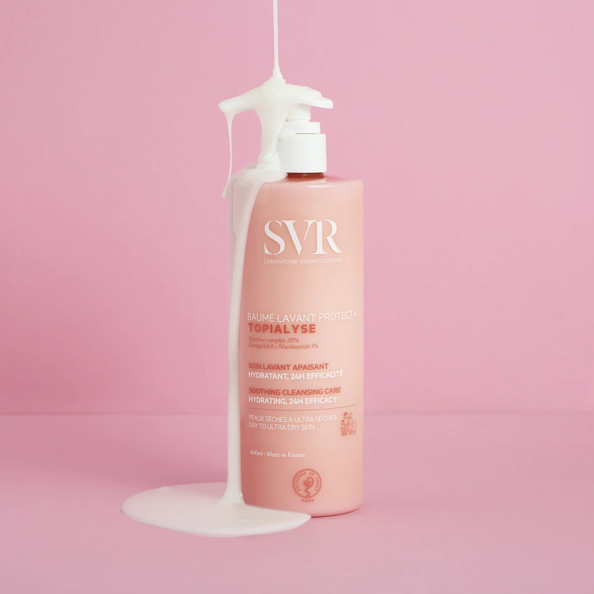 Pink bottle with white pump on a pink background