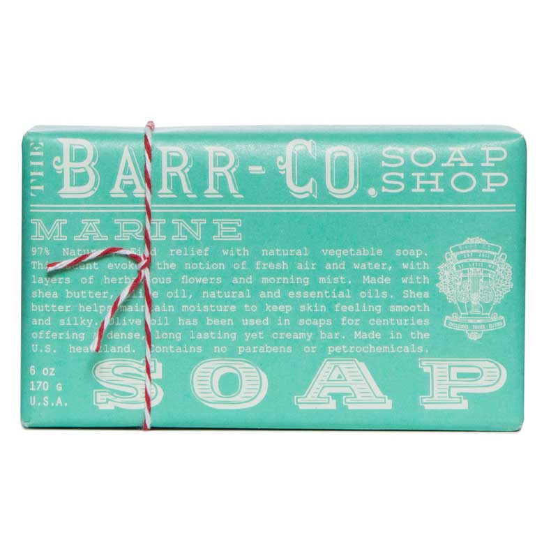 A green bar of soap with 'BARR-Co.SOAP SHOP MARINE' printed on it, tied with a red and white string.