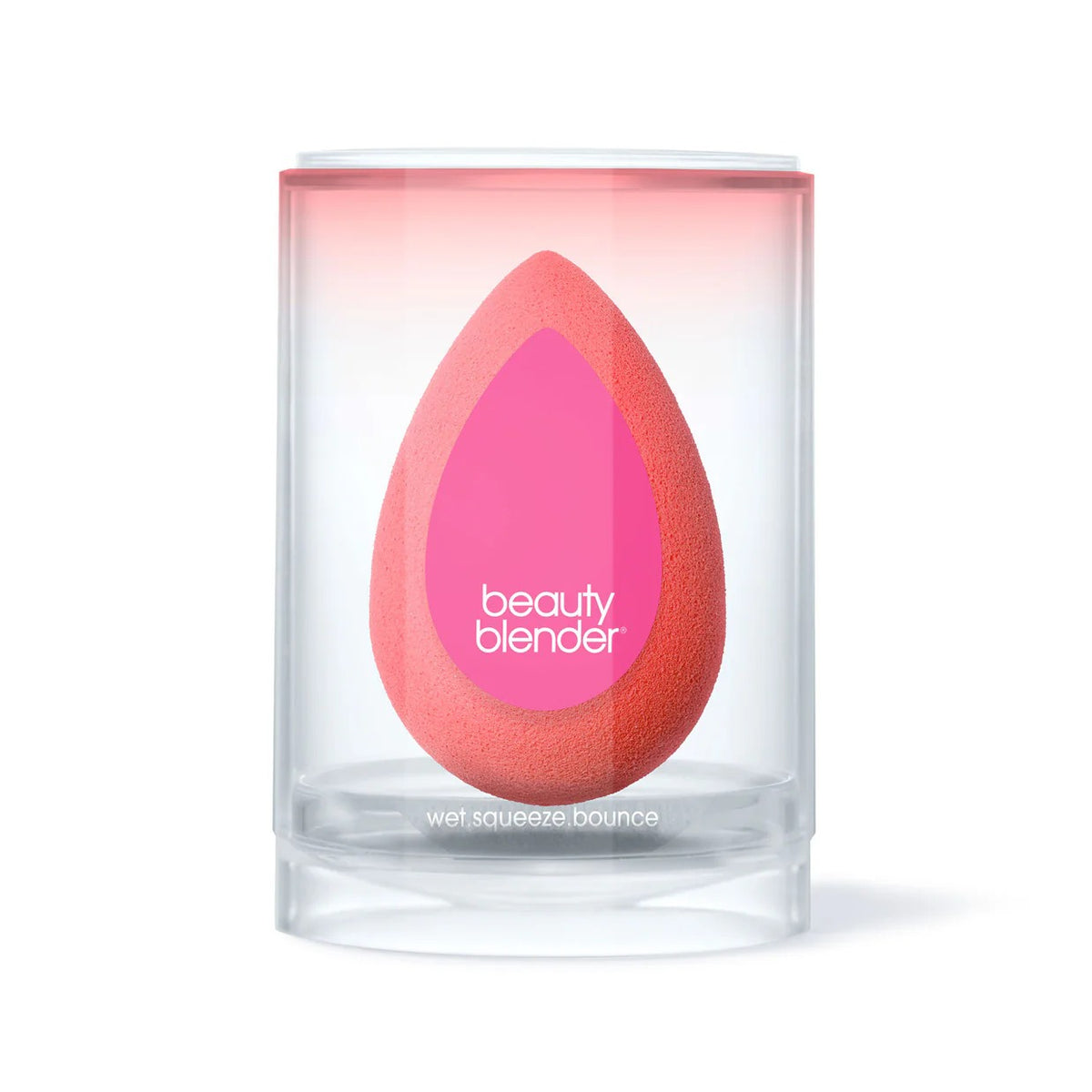 Pink beauty blender in a clear container on a white background