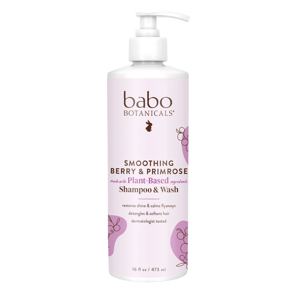 A pump bottle of Babo Botanicals Smoothing Berry & Primrose Shampoo & Wash with purple and green label design.