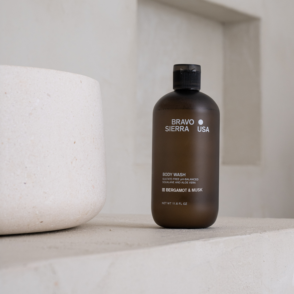 Bravo Sierra Body Wash bottle on a concrete countertop. 