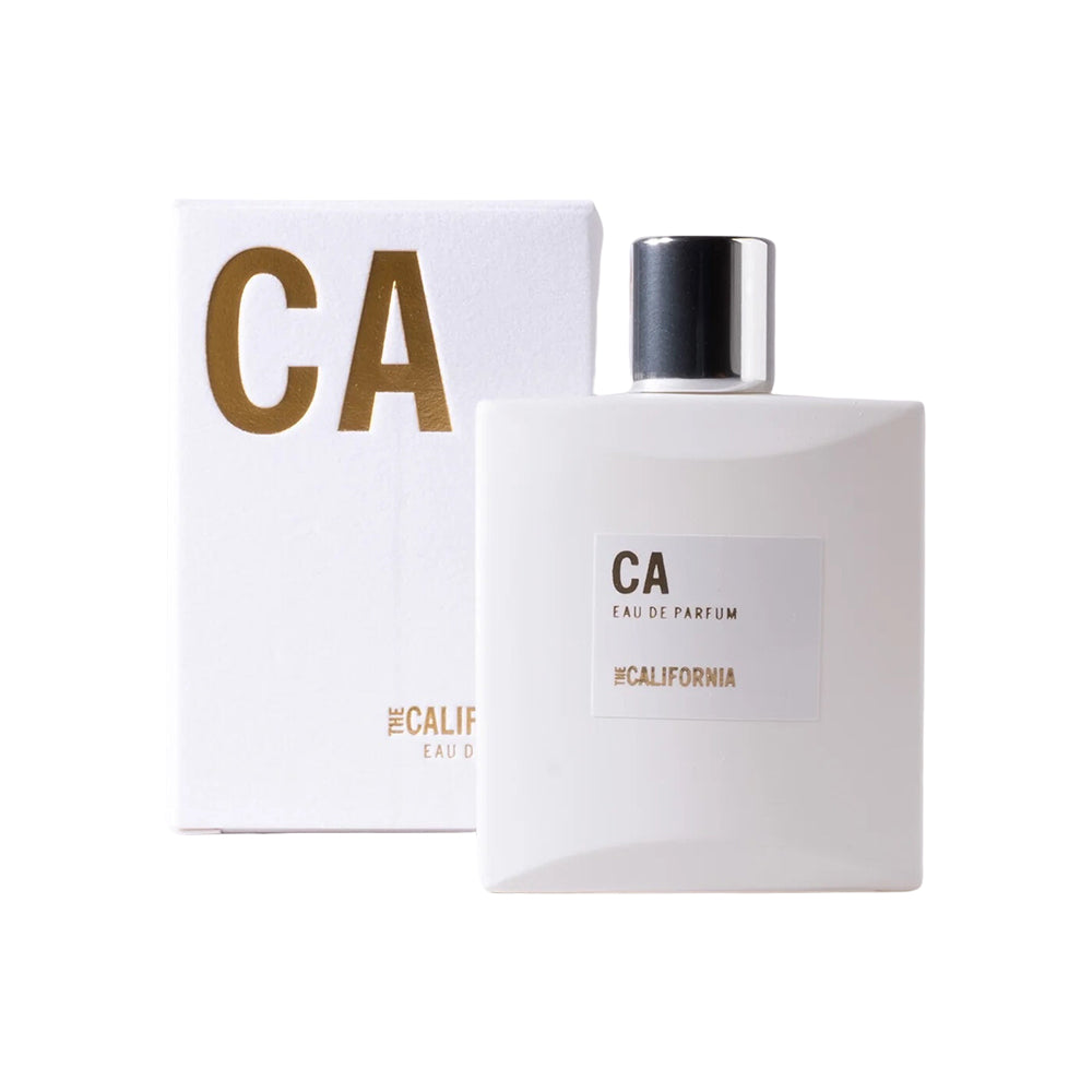 Perfume bottle next to its box on a white background