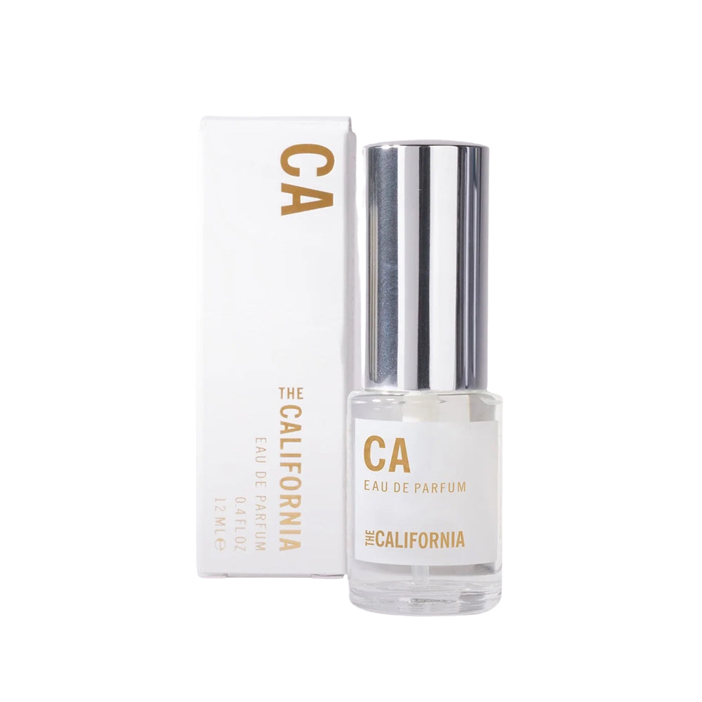 Perfume bottle next to its box on a white background