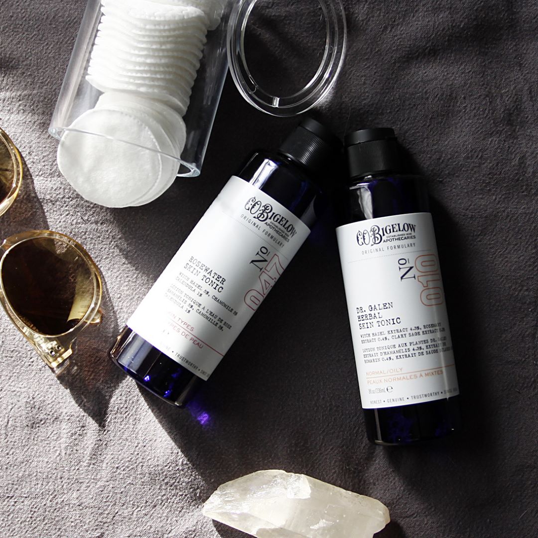 CO Bigelow Rosewater Skin Tonic and Dr Galen Herbal Skin Tonic on grey towel with cotton rounds and glasses 