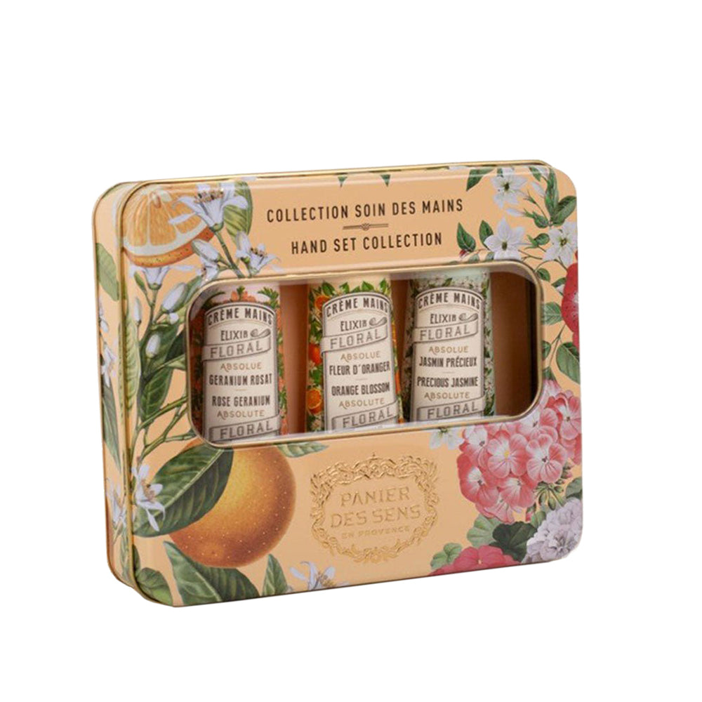 Panier Des Sens Gift Tin.  Three tubes (Rose Geranium Orange Blossom  and Precious Jasmine) show through a clear screened cut-out of a decorative tin with pictures of flowers and fruit. 
