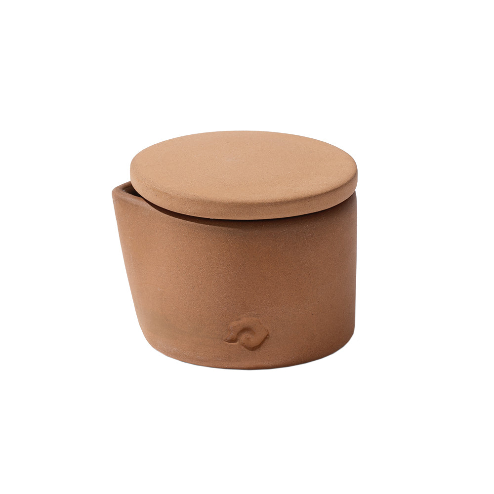 Brown candle with a lid on a white background