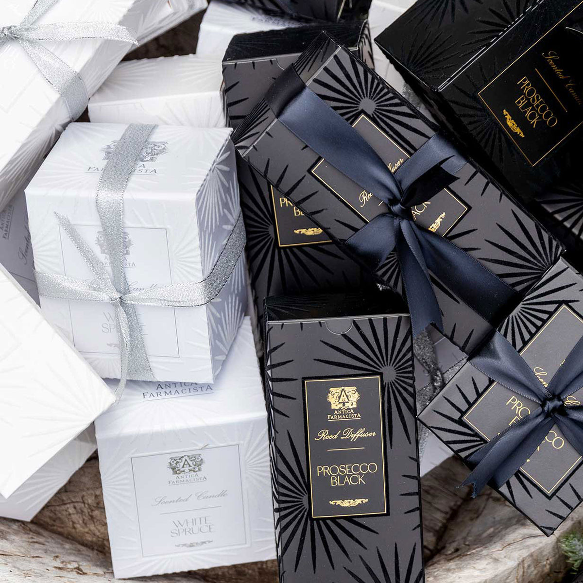 White boxes labeled White Spruce, and Black Boxes labeled Prosecco Black on a textured Surface.
